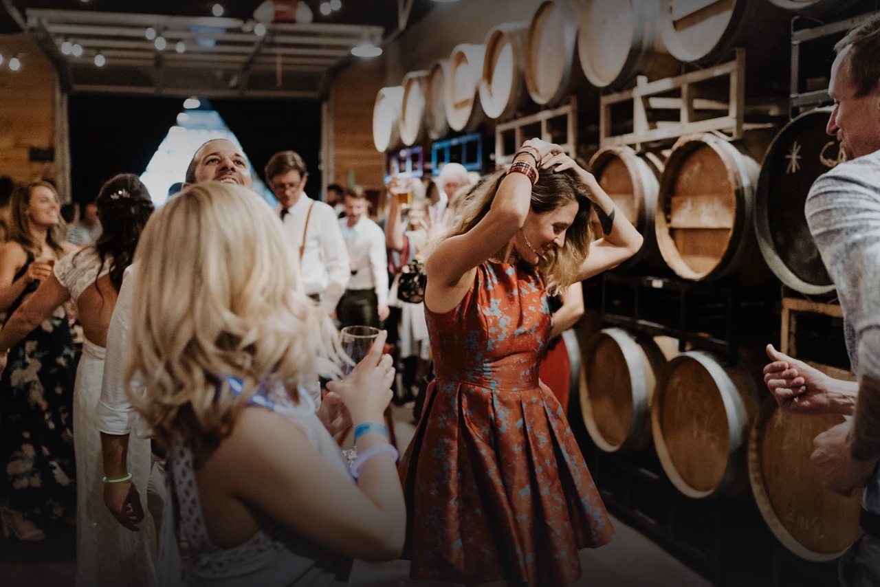 Guests dancing among the wine barrels at ENSO
