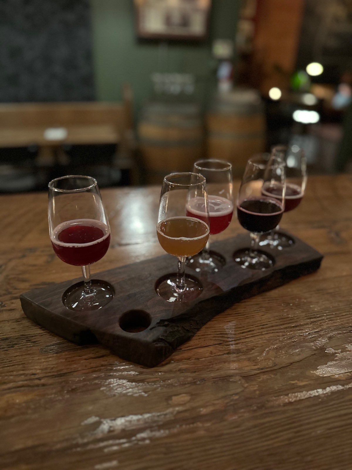 A colorful flight of five ENSO wines in a live-edge walnut board