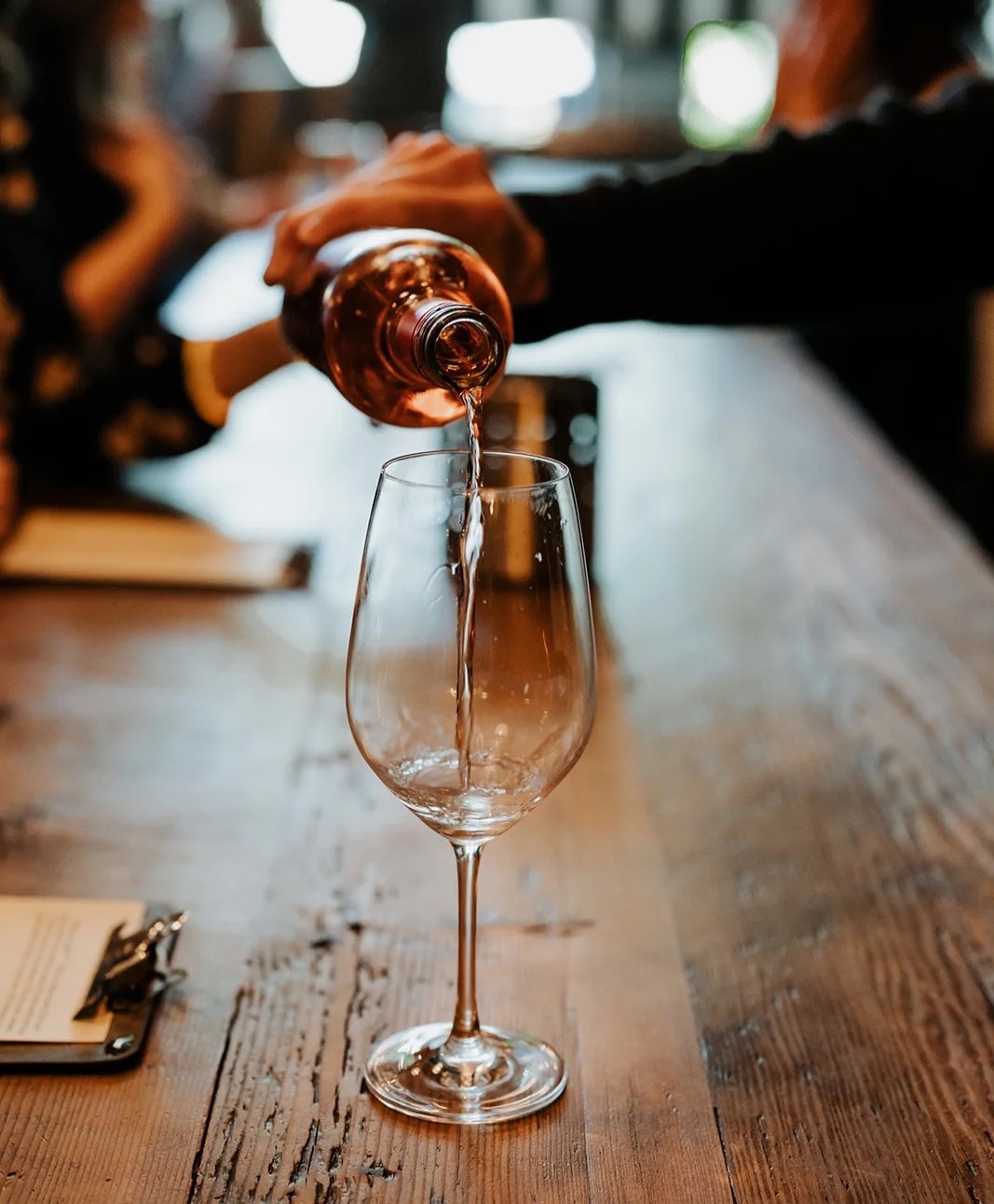 A glass of ENSO red wine being poured at the bar